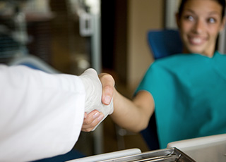 Teen girl shaking dentist's hand