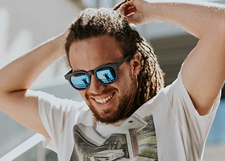 Smiling man outdoors wearing sunglasses