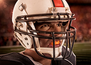 Man with football helmet and mouthguard