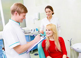 Smiling woman talking to dentist