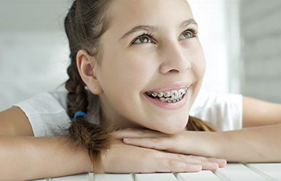 Smiling girl with traditional braces